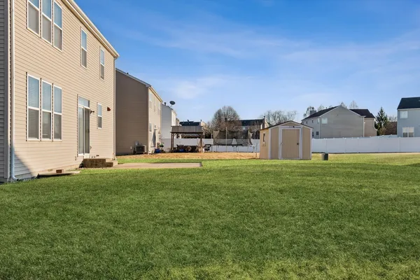 a view of a house with a backyard