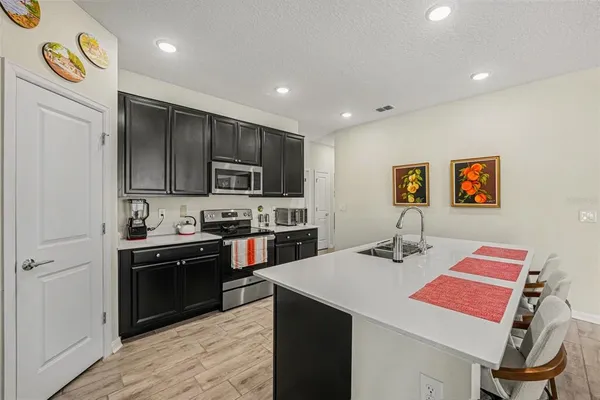 a kitchen with a sink cabinets and stainless steel appliances