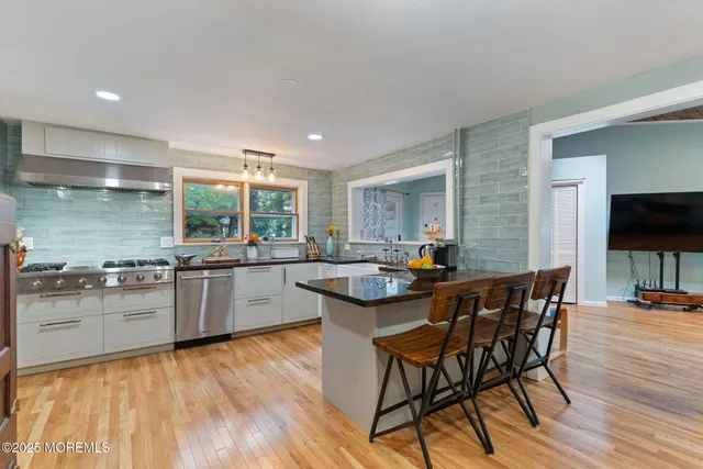 a dining room with furniture and wooden floor