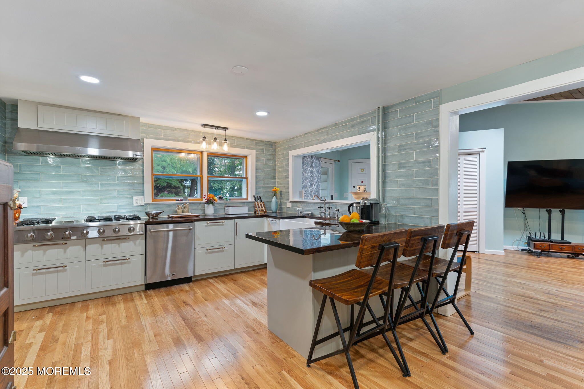 139 Monmouth Avenue Atlantic Highlands, NJ 07716 - Photo 14 of 40 a kitchen with stainless steel appliances kitchen island granite countertop a table chairs sink and cabinets
