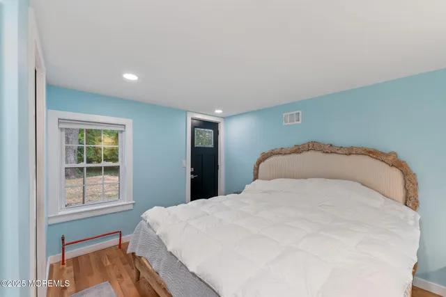 a view of a livingroom with furniture and hardwood floor