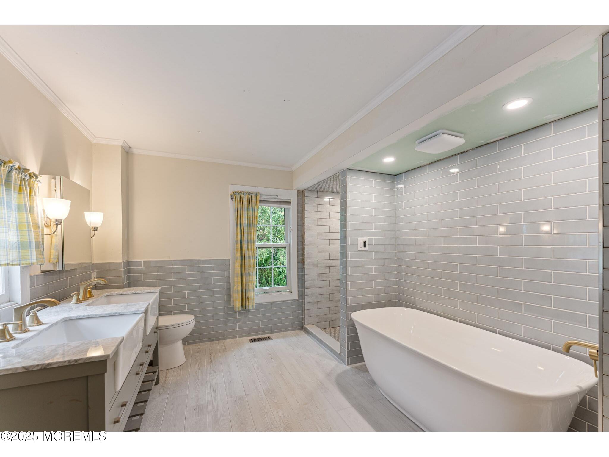 139 Monmouth Avenue Atlantic Highlands, NJ 07716 - Photo 26 of 40 a bathroom with a granite countertop sink a toilet a mirror and shower