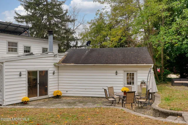 a front view of a house with a yard table and chairs