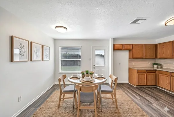 an empty room with windows and cabinet