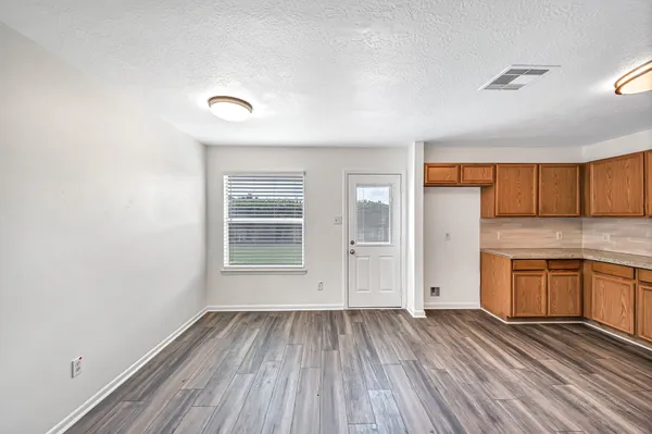 a kitchen with stainless steel appliances granite countertop a sink stove and cabinets