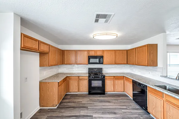 a kitchen with a granite countertop sink and a granite counter tops