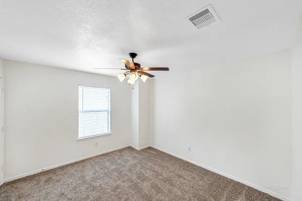 a bathroom with a granite countertop sink a mirror and bathtub