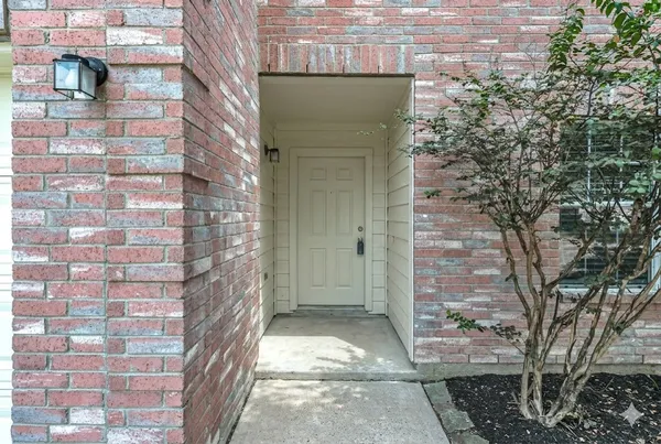 an empty room with wooden floor cabinet and windows