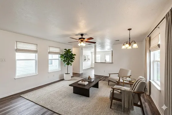 a living room with furniture and a potted plant