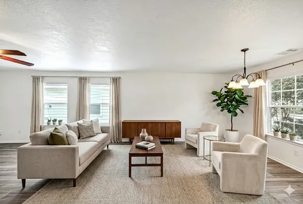 a view of empty room with wooden floor and window