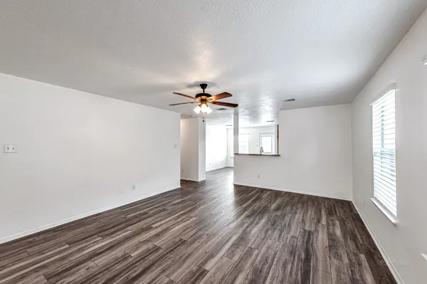 wooden floor in an empty room with a window