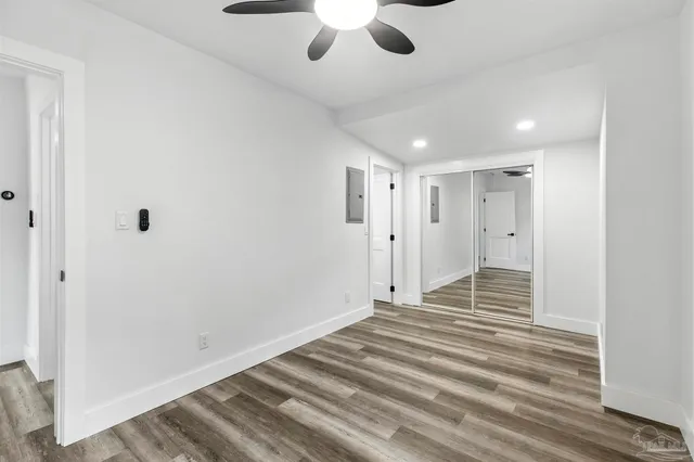 a view of a room with wooden floor and fan