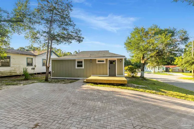 a view of a house with pool and a yard