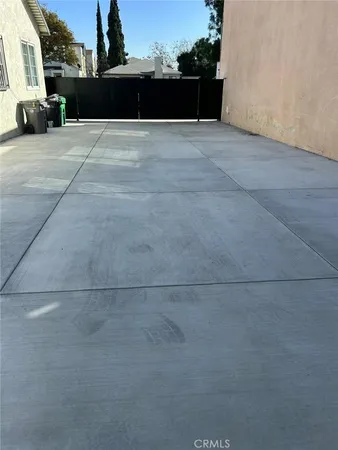 a swimming pool with yard in front of it