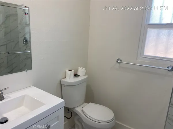 a white toilet sitting next to a bathroom sink