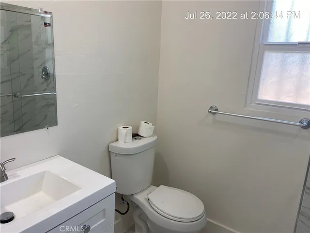 a white toilet sitting next to a bathroom sink