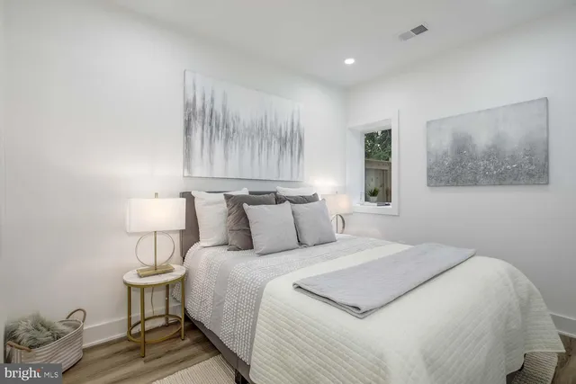 a bedroom with bed and a night stand