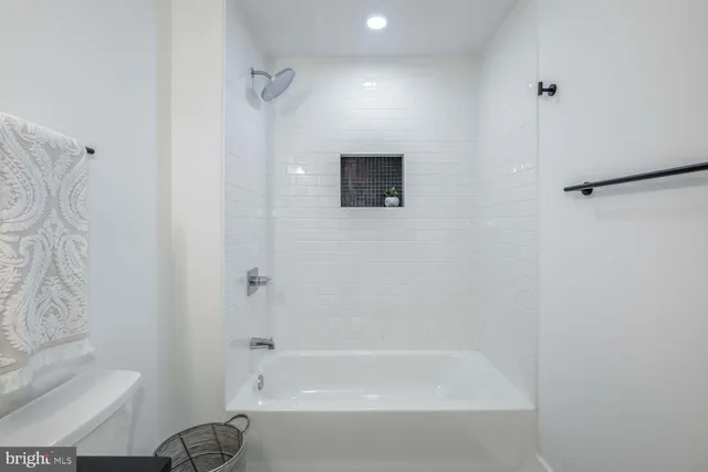 a bathroom with a bathtub and a shower