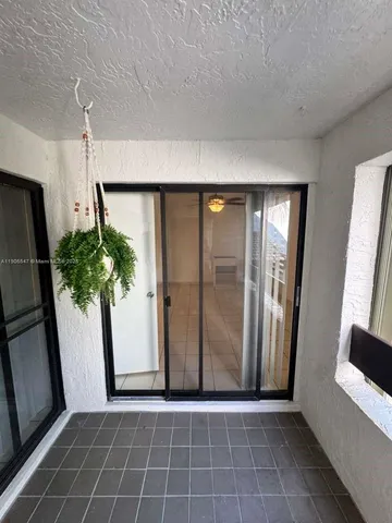 a view of entryway with window and wooden floor
