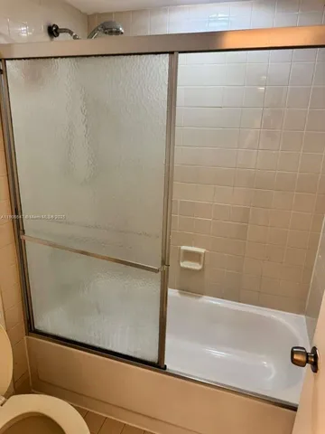 a bathroom with a shower and a toilet