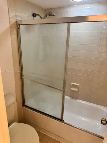 a bathroom with a shower and a toilet