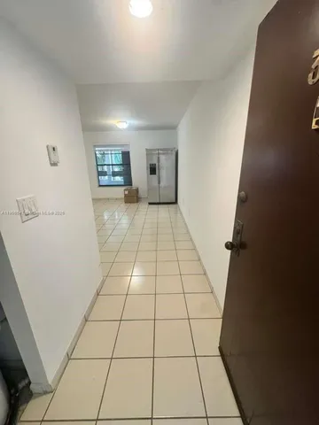 a view of an empty room and a window