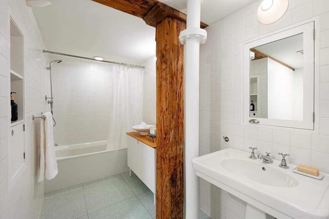 288 West Street, Unit PH Manhattan, NY 10013 - Photo 11 of 19 a bathroom with a bathtub sink vanity and mirror
