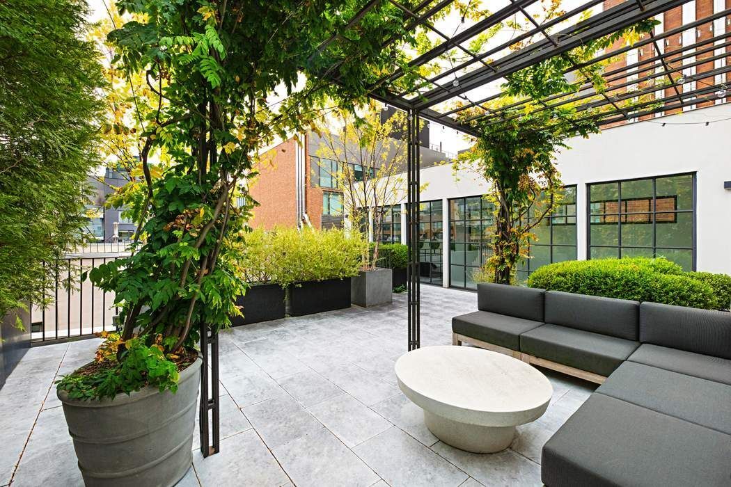288 West Street, Unit PH Manhattan, NY 10013 - Photo 17 of 19 a view of a patio with couches table and chairs and potted plants