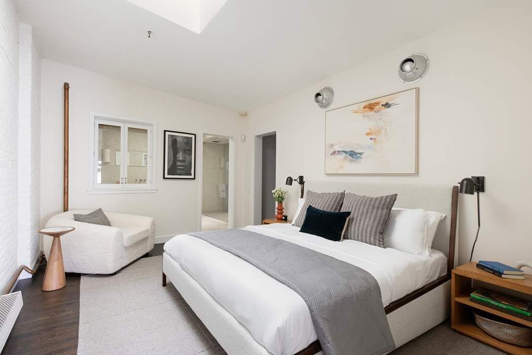 288 West Street, Unit PH Manhattan, NY 10013 - Photo 5 of 19 a bedroom with bed and a couch