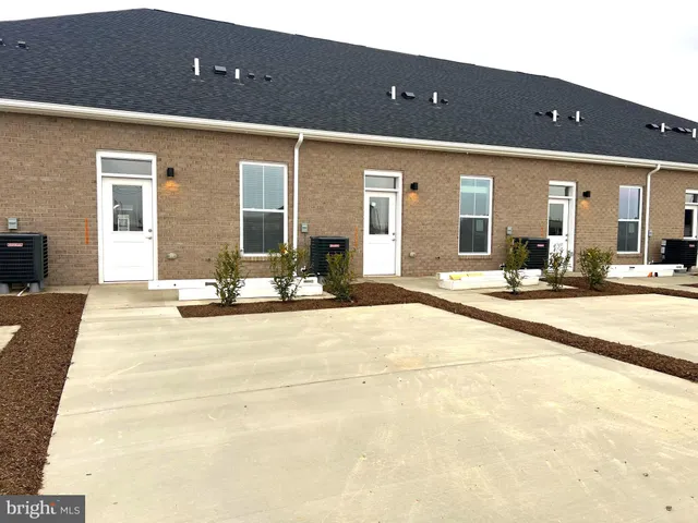 a view of a building with a table and chairs in patio