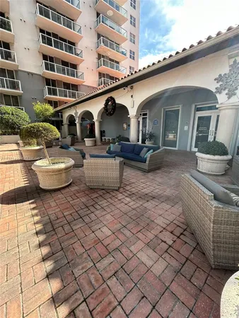 a view of a patio with couches and potted plants
