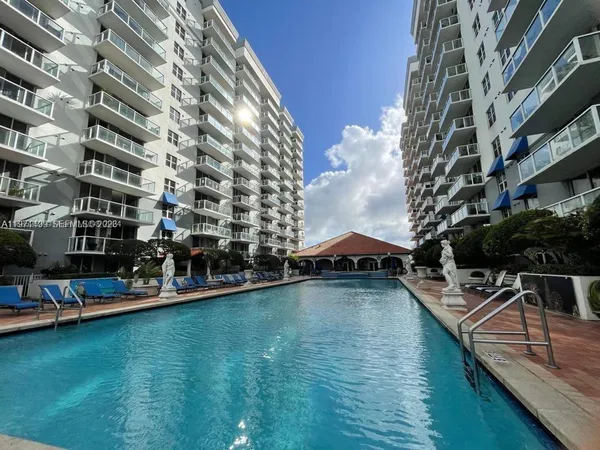 a view of a swimming pool with outdoor seating