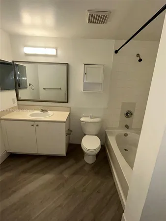a bathroom with a toilet a sink and bathtub