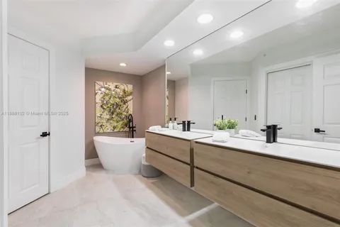 a large white room with a large window and white doors