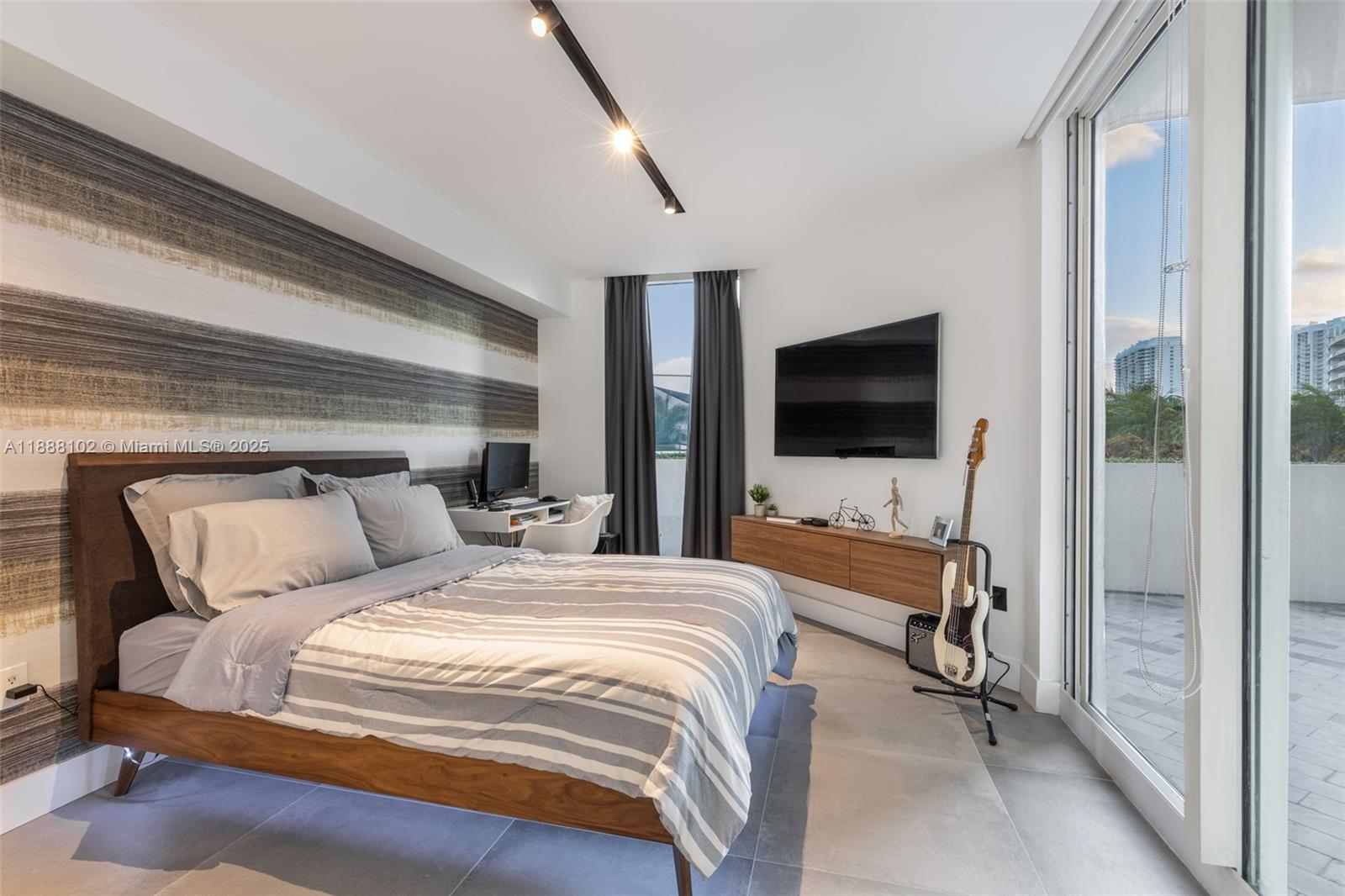 3370 Hidden Bay Drive, Unit 409 Aventura, FL 33180 - Photo 15 of 20 a bedroom with a bed and a flat screen tv