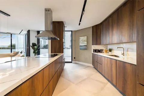 a large kitchen with stainless steel appliances kitchen island granite countertop a sink and cabinets