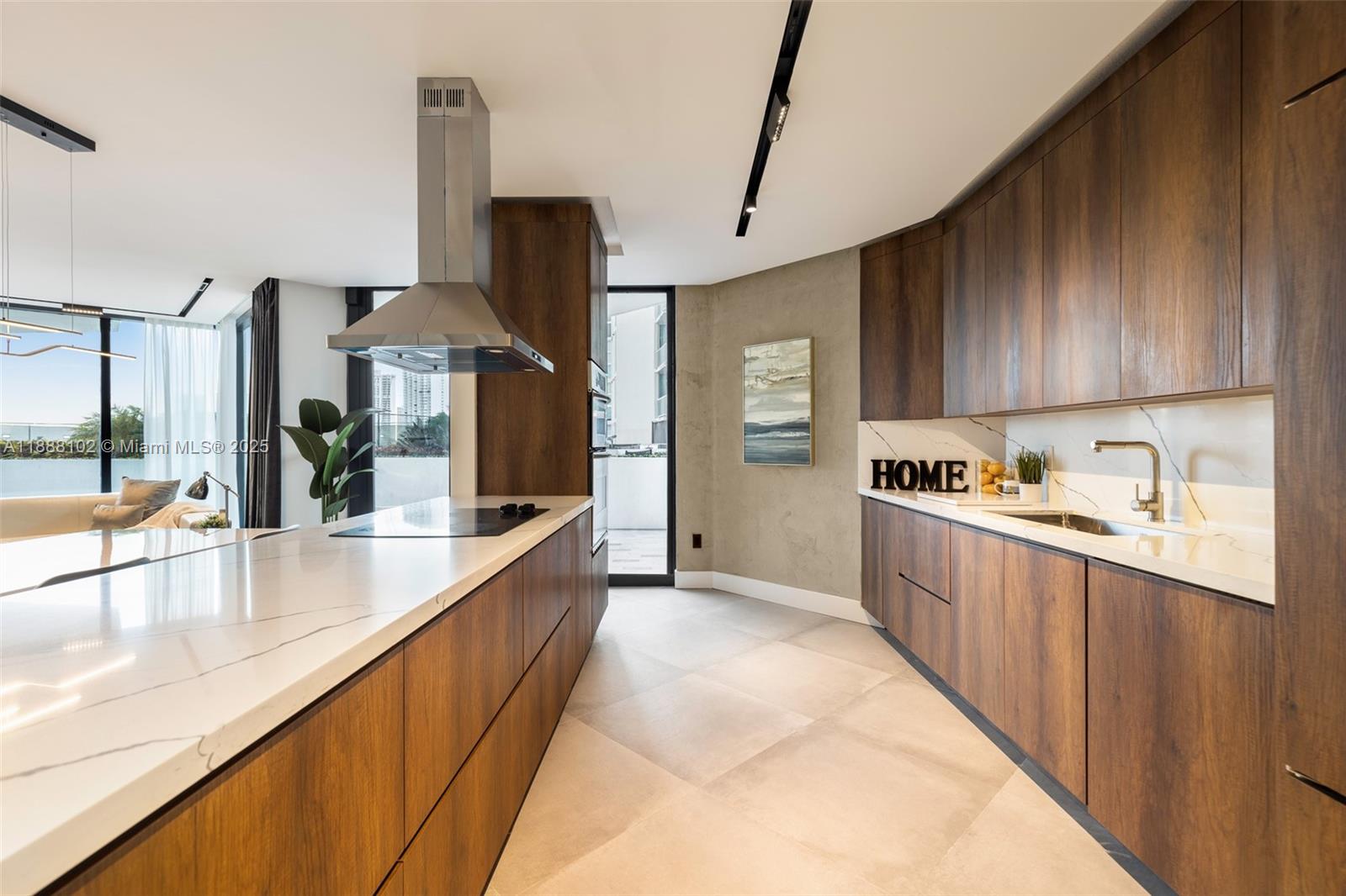 3370 Hidden Bay Drive, Unit 409 Aventura, FL 33180 - Photo 2 of 20 a large kitchen with stainless steel appliances kitchen island granite countertop a sink and cabinets