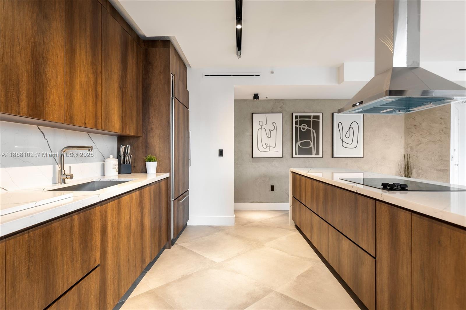 3370 Hidden Bay Drive, Unit 409 Aventura, FL 33180 - Photo 5 of 20 a kitchen with stainless steel appliances a sink dishwasher a refrigerator and cabinets with wooden floor