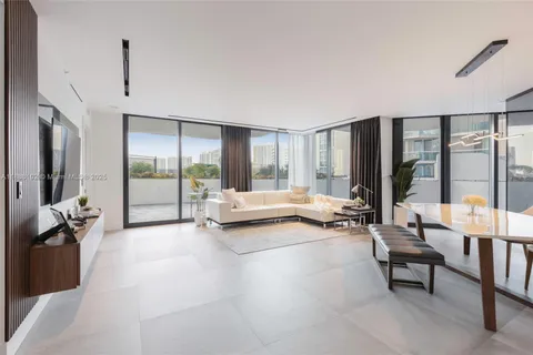 a living room with furniture and large windows