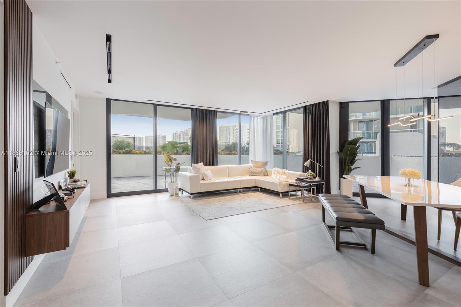 3370 Hidden Bay Drive, Unit 409 Aventura, FL 33180 - Photo 7 of 20 a living room with furniture and large windows