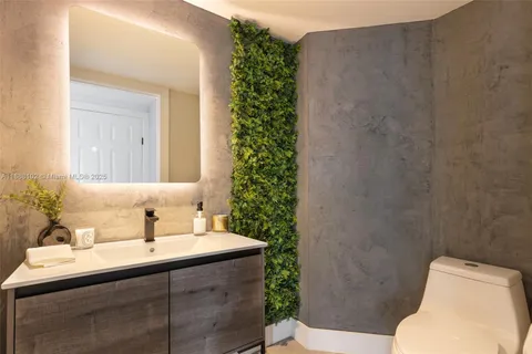 a bathroom with a sink toilet and mirror