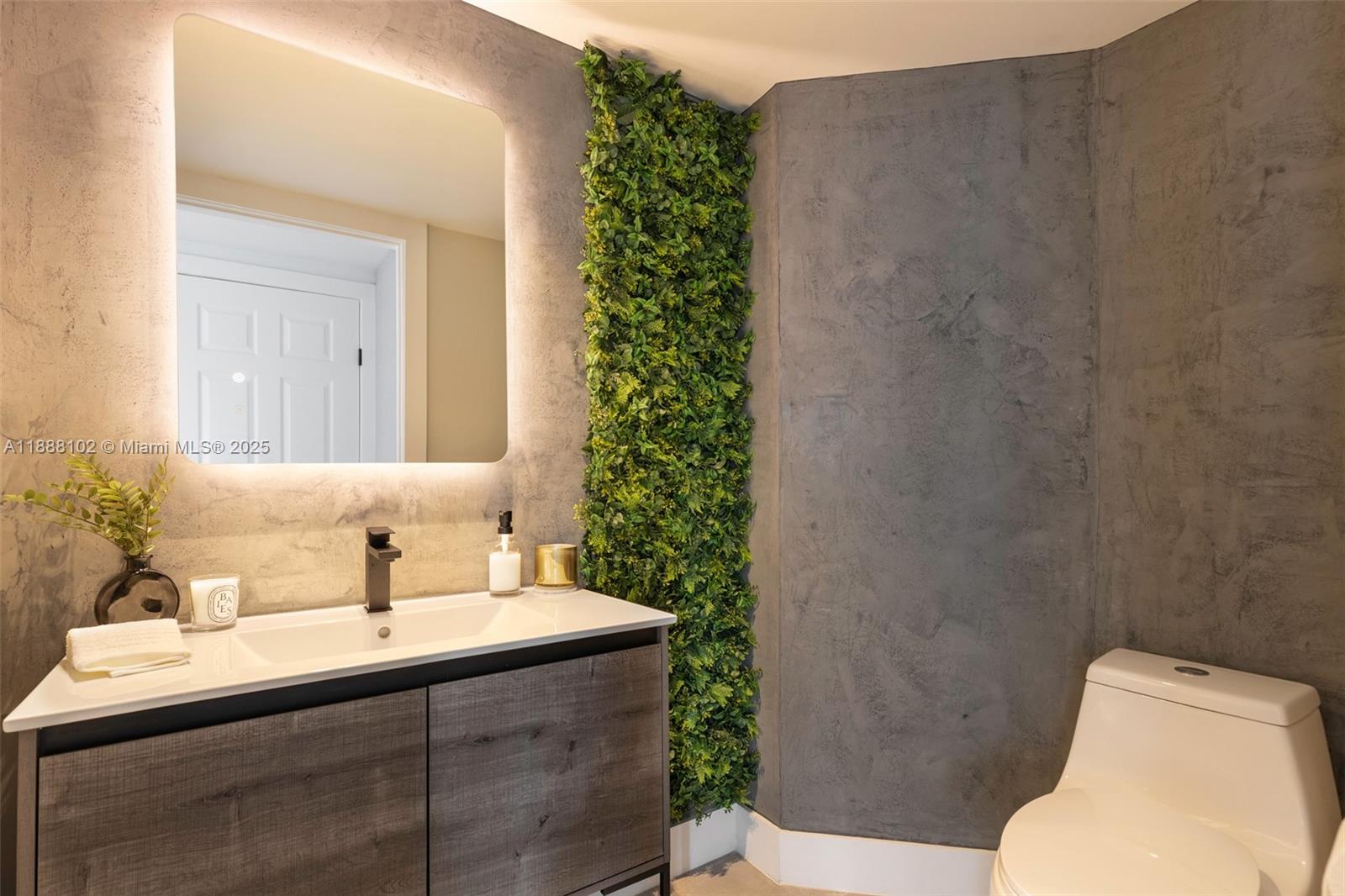 3370 Hidden Bay Drive, Unit 409 Aventura, FL 33180 - Photo 9 of 20 a bathroom with a sink toilet and mirror