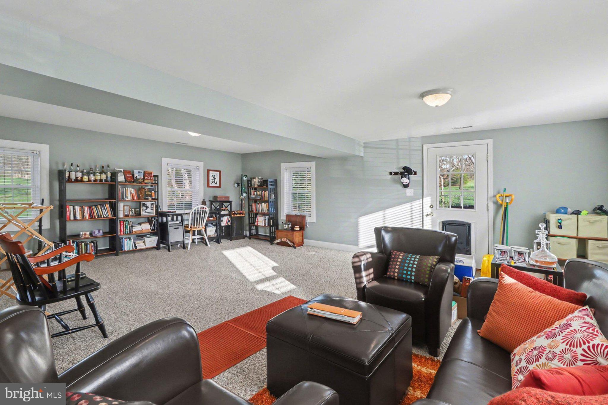 88 McAllister Church Road Carlisle, PA 17015 - Photo 21 of 43 a living room with furniture a rug and a bookshelf