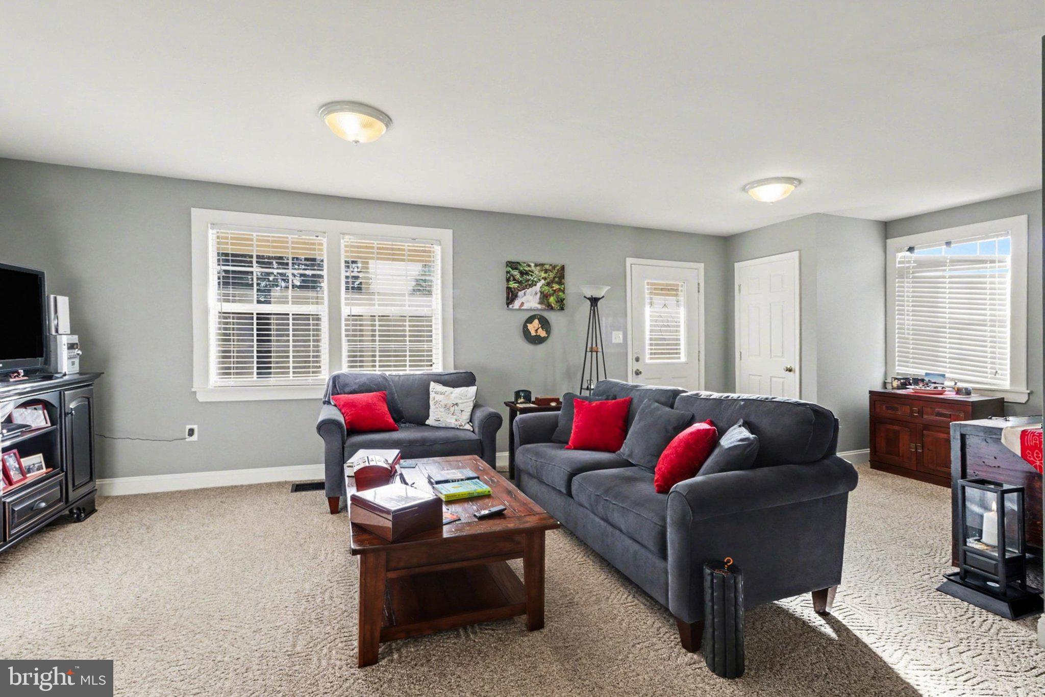 88 McAllister Church Road Carlisle, PA 17015 - Photo 3 of 43 a living room with furniture a flat screen tv and a window