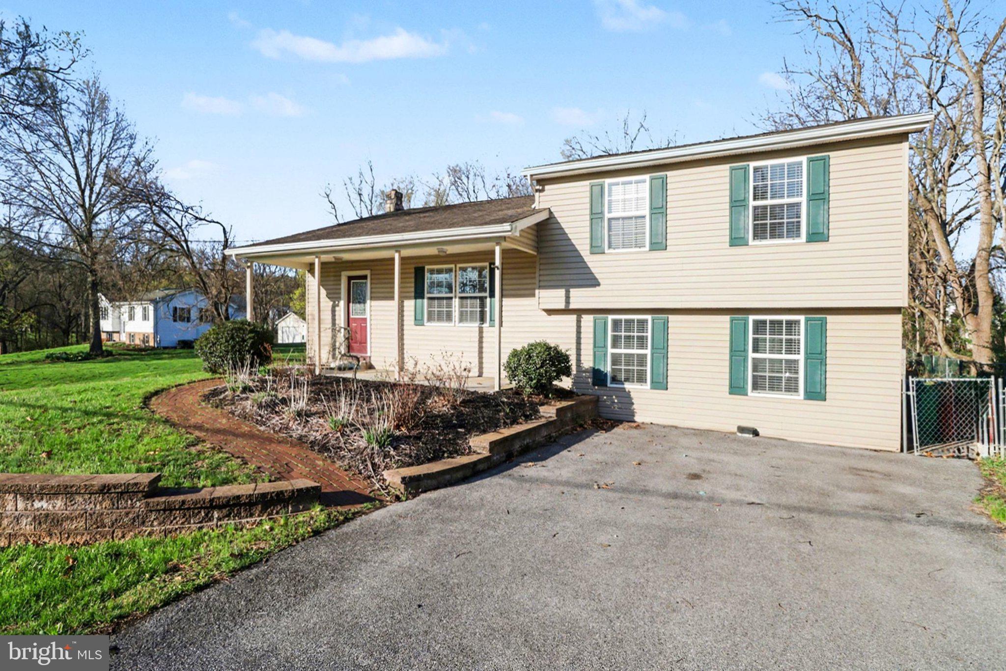 88 McAllister Church Road Carlisle, PA 17015 - Photo 31 of 43 a front view of a house with a garden