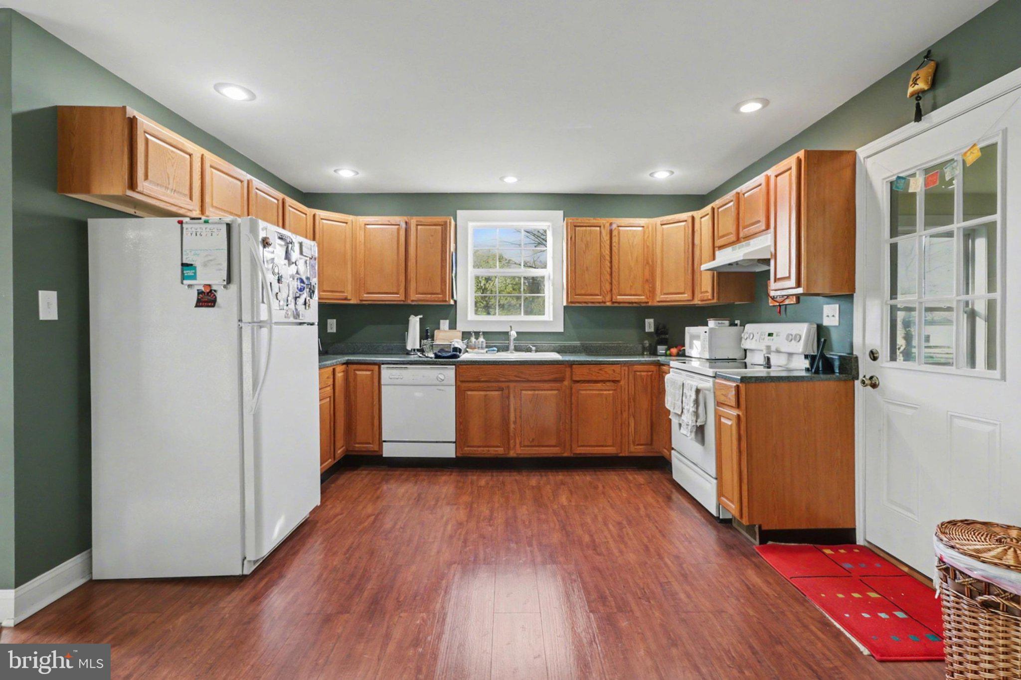 88 McAllister Church Road Carlisle, PA 17015 - Photo 9 of 43 a kitchen with kitchen island granite countertop wooden floors stainless steel appliances and a window