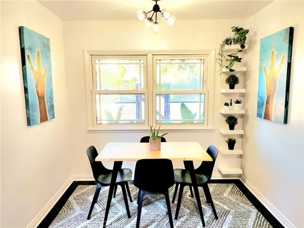 a view of a dining room with furniture and chandelier