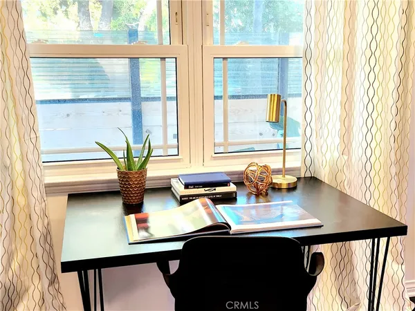 a view of a dining room with furniture and window