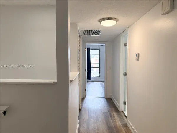 a view of a room with wooden floor and closet