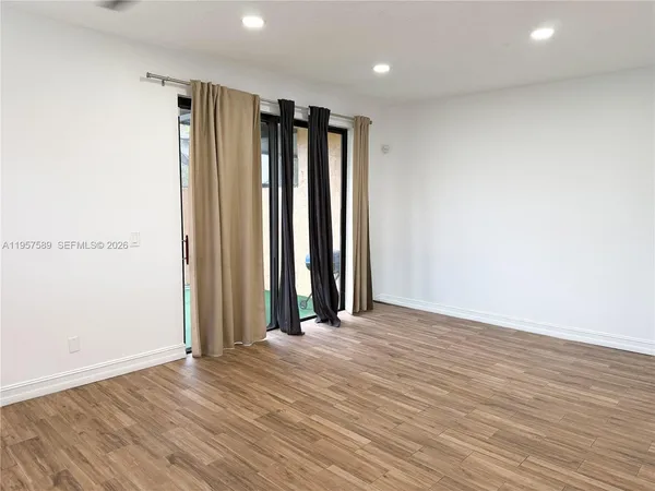 a view of a room with wooden floor